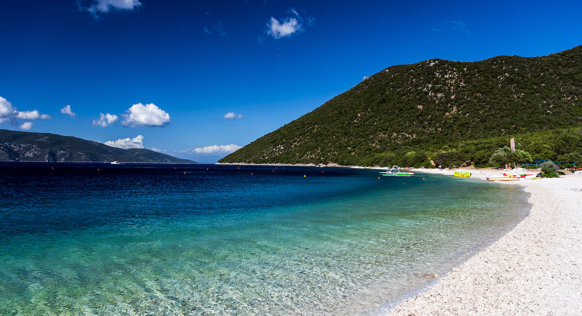 Embark on a breathtaking day trip to Antisamos Beach in Kefalonia, Greece. Experience the sheer beauty of this stunning beach, known for its crystal-clear turquoise waters and dramatic mountainous backdrop. Relax on the smooth white pebbles, swim in the refreshing sea, and soak up the sun on the inviting shoreline. Explore the surrounding lush landscape, hike along coastal paths, or indulge in water sports activities. Antisamos Beach promises a day of natural splendour, serenity, and unforgettable moments in Kefalonia