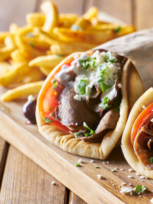 Experience the mouthwatering flavours of Kefalonia with the classic Souvlaki Gyros. This beloved Greek dish features tender grilled meat, typically pork or chicken, wrapped in a warm pita bread along with fresh vegetables, tzatziki sauce, and a sprinkle of herbs. The combination of succulent meat, tangy sauce, and crispy pita creates a delightful explosion of flavours. Whether enjoyed as a quick street food snack or a satisfying meal, the Souvlaki Gyros is a must-try dish in Kefalonia. Indulge in this Greek favourite and savor the authentic tastes of the island's vibrant culinary scene.