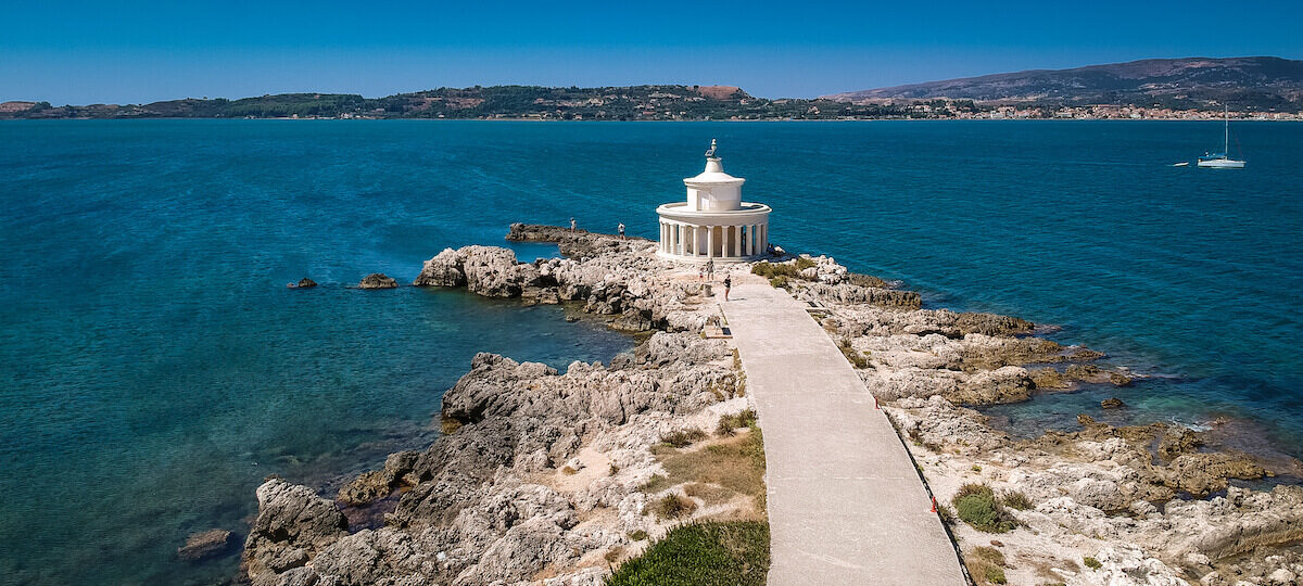 Bask in the picturesque charm of the lighthouse of saint theodore in kefalonia, greece. Perched atop a rocky promontory, this historic lighthouse stands as a beacon of light, guiding ships along the coast. The elegant white tower, surrounded by the azure waters of the ionian sea, creates a striking contrast against the rugged landscape. Take in the panoramic views of the coastline, where the lighthouse overlooks the vast expanse of the sea. The lighthouse of saint theodore is not only a navigational landmark but also a captivating symbol of kefalonia's maritime heritage and natural beauty