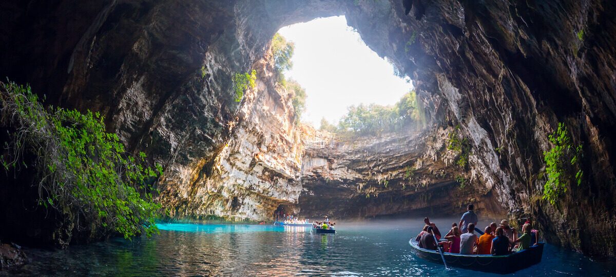 Embark on a magical journey into the depths of Melissani Cave, a mesmerising natural wonder in Kefalonia, Greece. Step into a world of awe-inspiring beauty as you explore the crystal-clear turquoise waters surrounded by breathtaking limestone formations. Sunlight filters through a collapsed roof, casting ethereal reflections on the water, creating a surreal and enchanting ambiance. Glide across the serene lake in a small boat, marvelling at the natural colours and textures that adorn the cave walls. Melissani Cave offers a unique and unforgettable experience, inviting you to witness the wonders of nature's artistry in the heart of Kefalonia